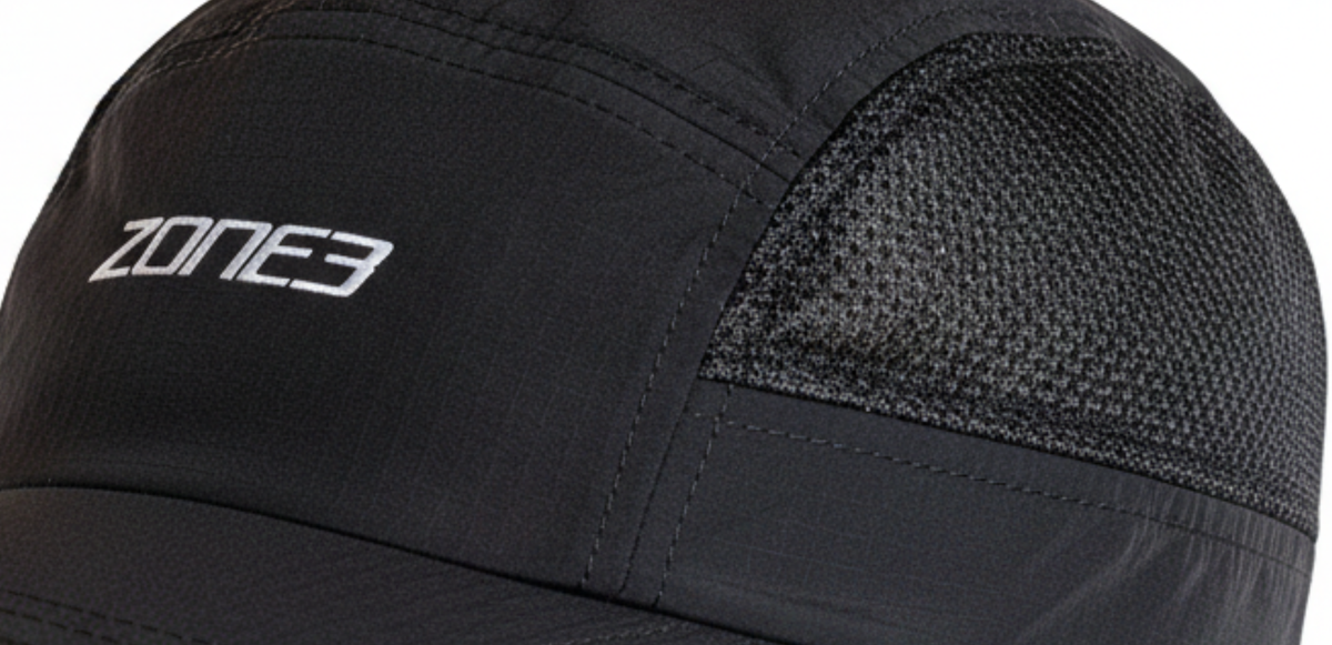 Close up of  mesh black cap with Zone3 logo on a white background