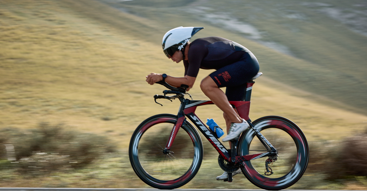 Man wearing zone3 Aeroforce-X Trisuit cycling on a blurred background