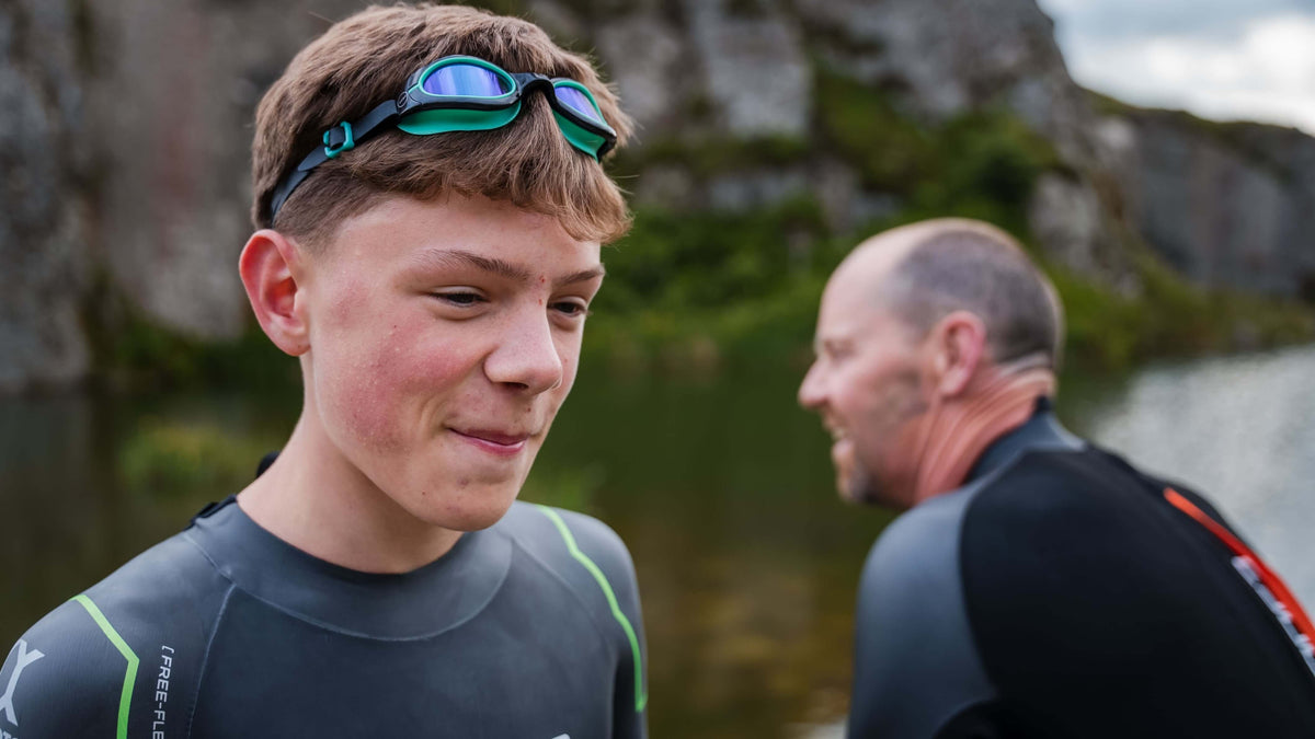 child wearing the Zone3 Aquahero  goggles and a Zone3 wetsuit