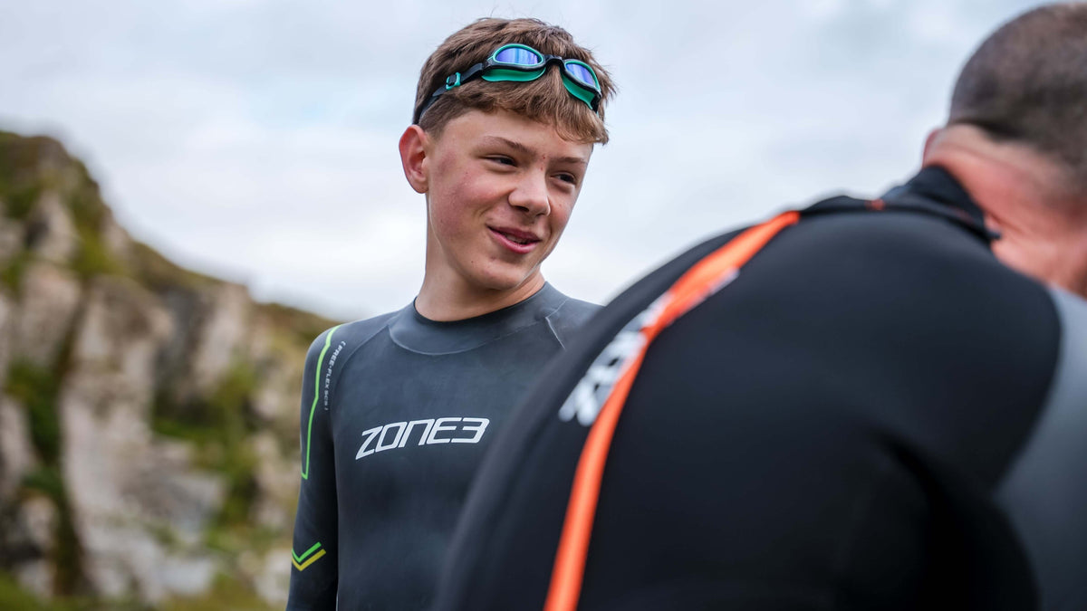 child wearing the Zone3 Aquahero  goggles and a Zone3 wetsuit