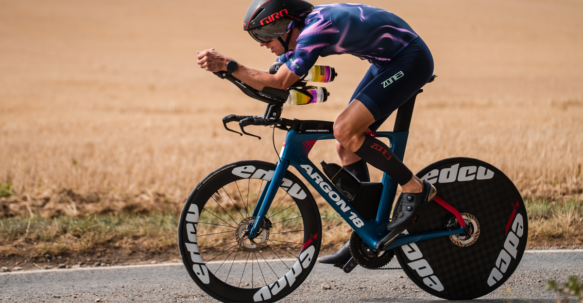 Person cycling wearing Zone3 trisuit with the Aeroforce-X II Calf Sleeves