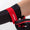 Person wearing ZONE3 neoprene gloves, showcasing the wrist strap for better insulation during cold water swimming.