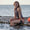 A woman wearing the Zone3 OWS Renew high neck swimsuit on a white background.