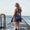 A woman wearing the Zone3 OWS Renew short leg kneeskin swimsuit on a white background.