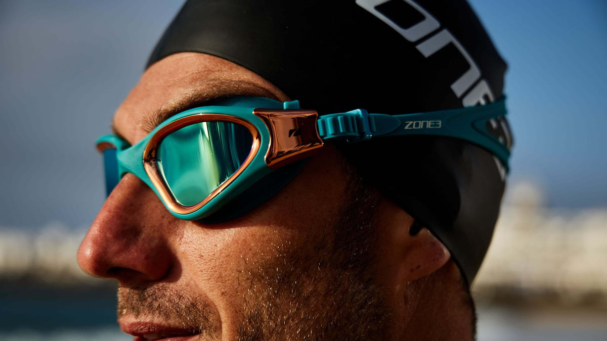 Close up of an athlete wearing the Zone3 Teal Copper Vapour goggles