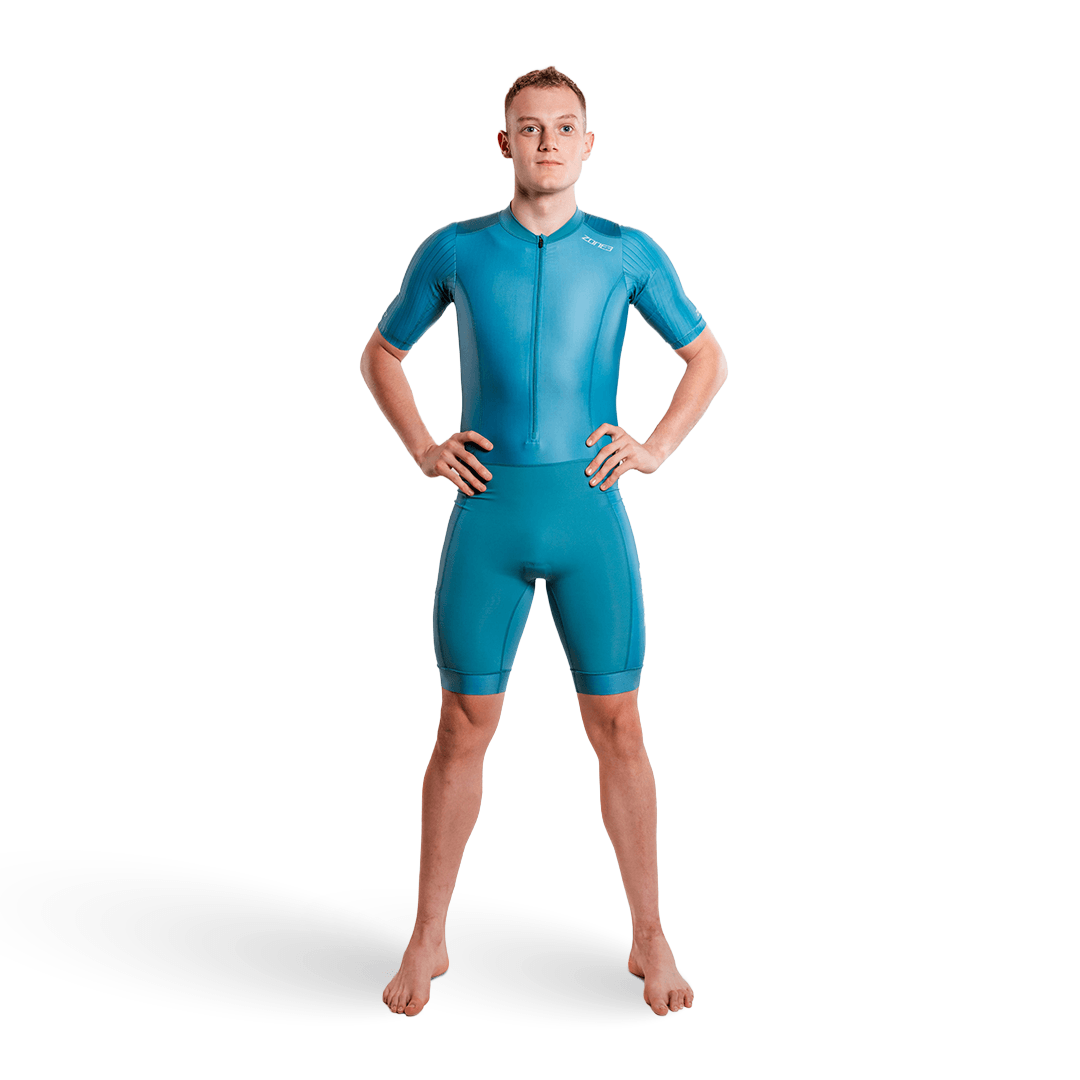 Athlete wearing the Activate short sleeve trisuit in teal on a white studio background.