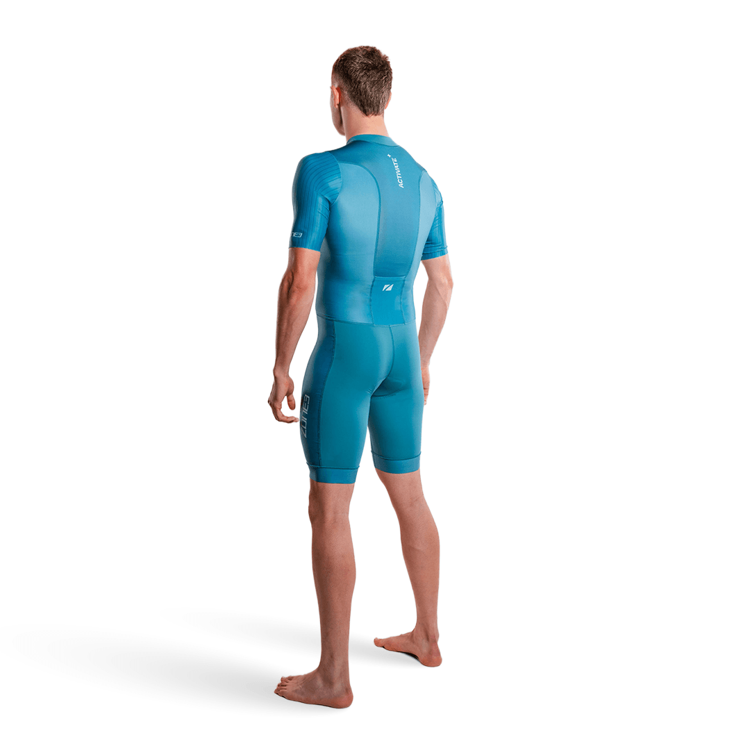 Athlete wearing the Activate short sleeve trisuit in teal on a white studio background.