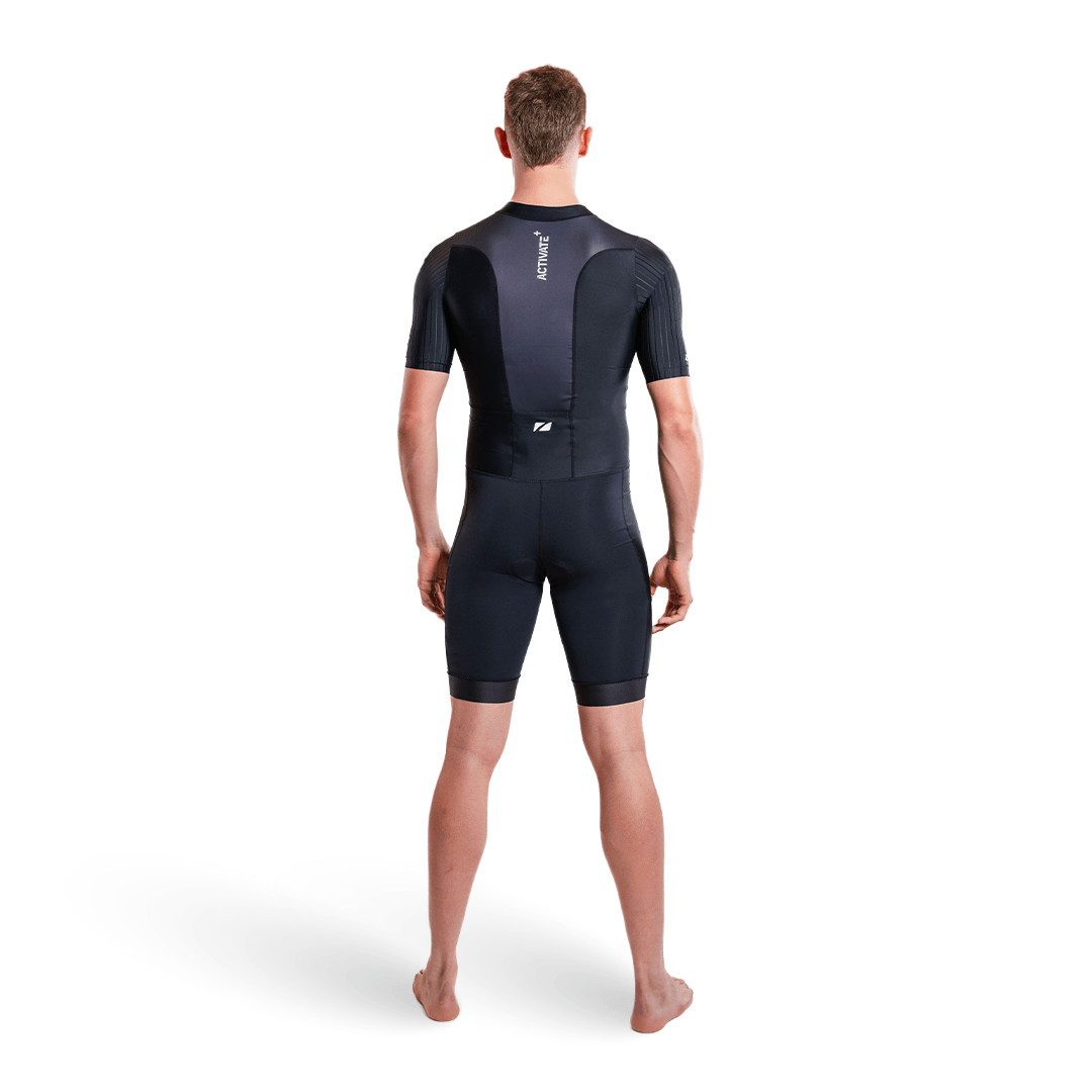 Athlete wearing the Activate short sleeve trisuit in black on a white studio background.