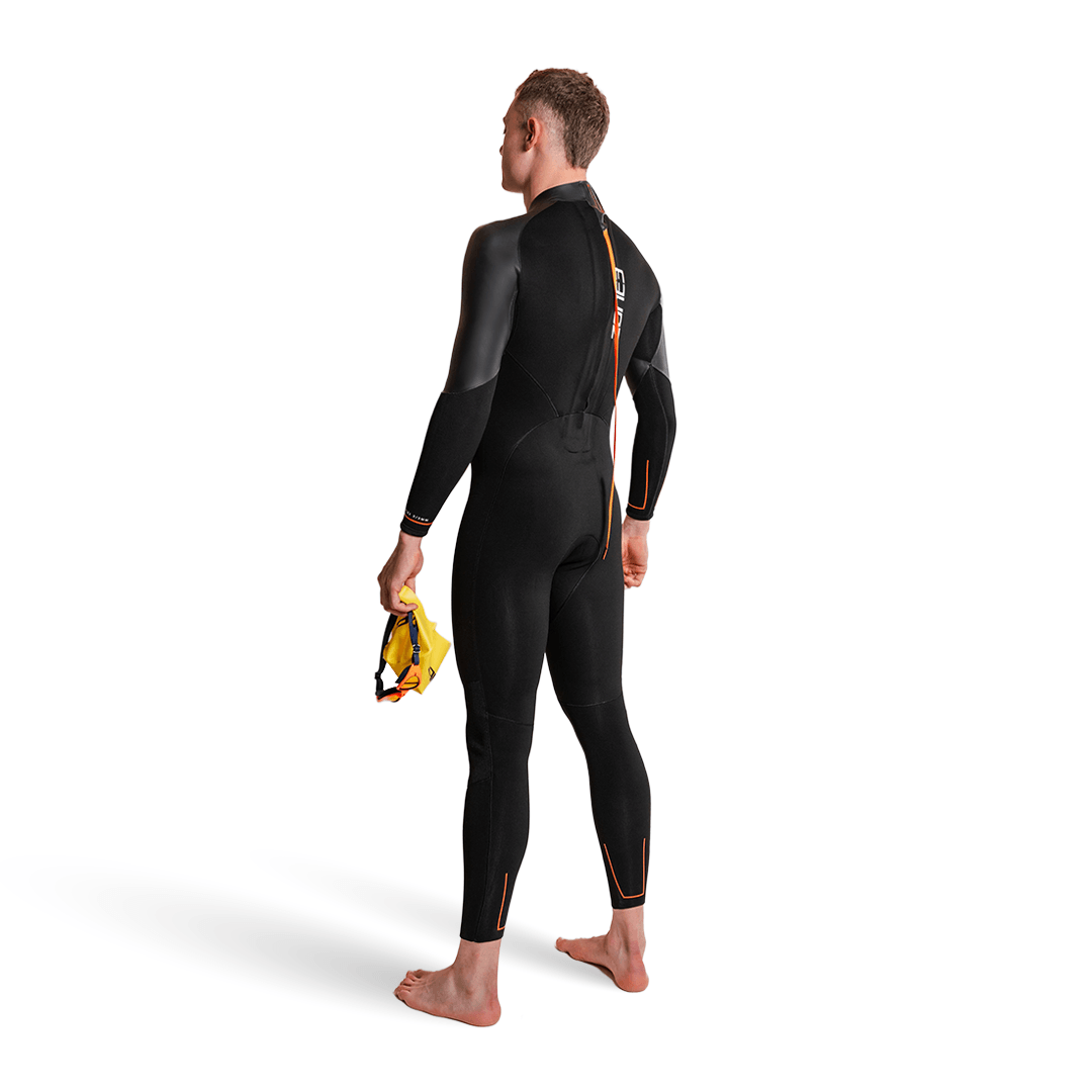 Active-Flex Wetsuit worn by a swimmer standing with a swim cap in hand, showcasing the sleek design.