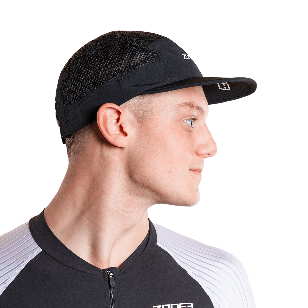 Man wearing a black mesh panel with a zone3 logo on a white background