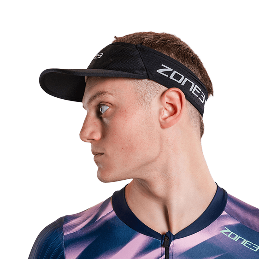 Man wearing zone3 black running visor with a zone3 logo on a white background