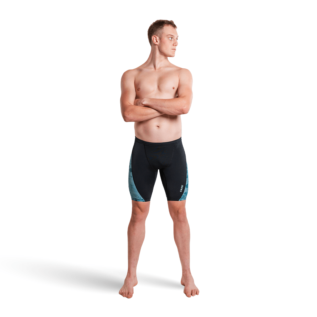 Man wearing black and teal Zone3 Jammers  on a white background