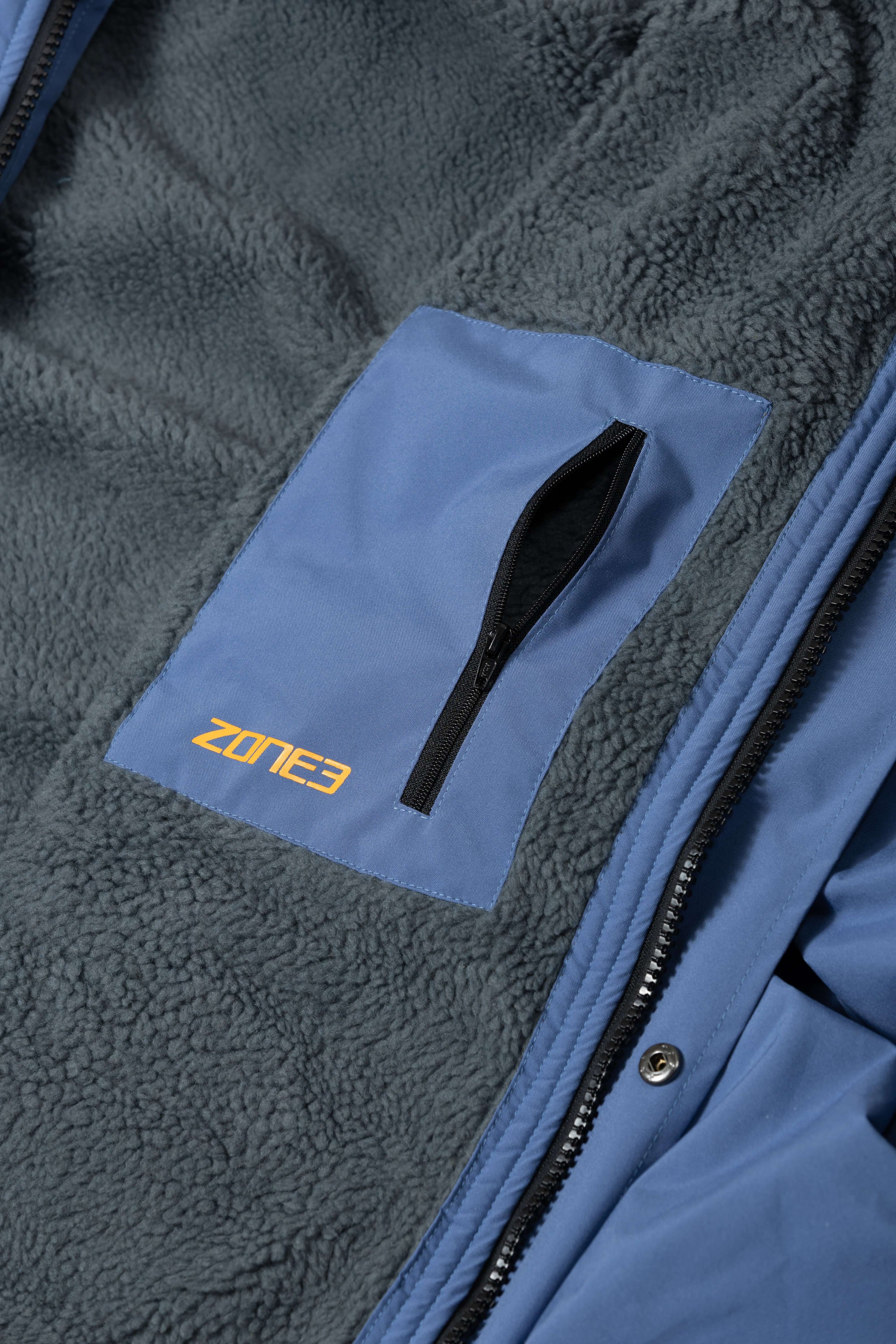 Close-up of internal zip chest pocket on fleece lining, embroidered with ZONE3 logo.