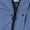 Close-up of the robe's front zip, with visible branded pull tab and logo patch inside the collar.