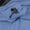 Detail of the adjustable hood drawcord and toggle on the Arctic blue fabric.