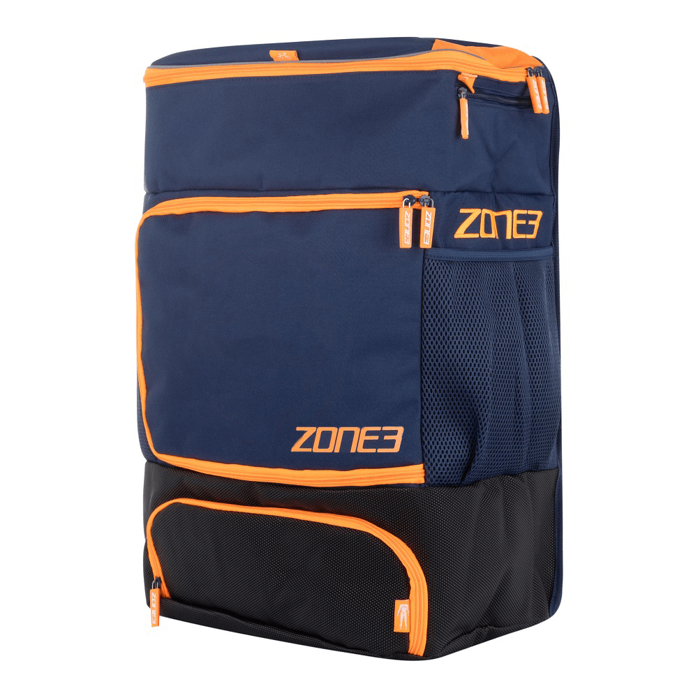A navy and orange ZONE3 transition backpack with multiple zippers and the brand logo visible on the side.