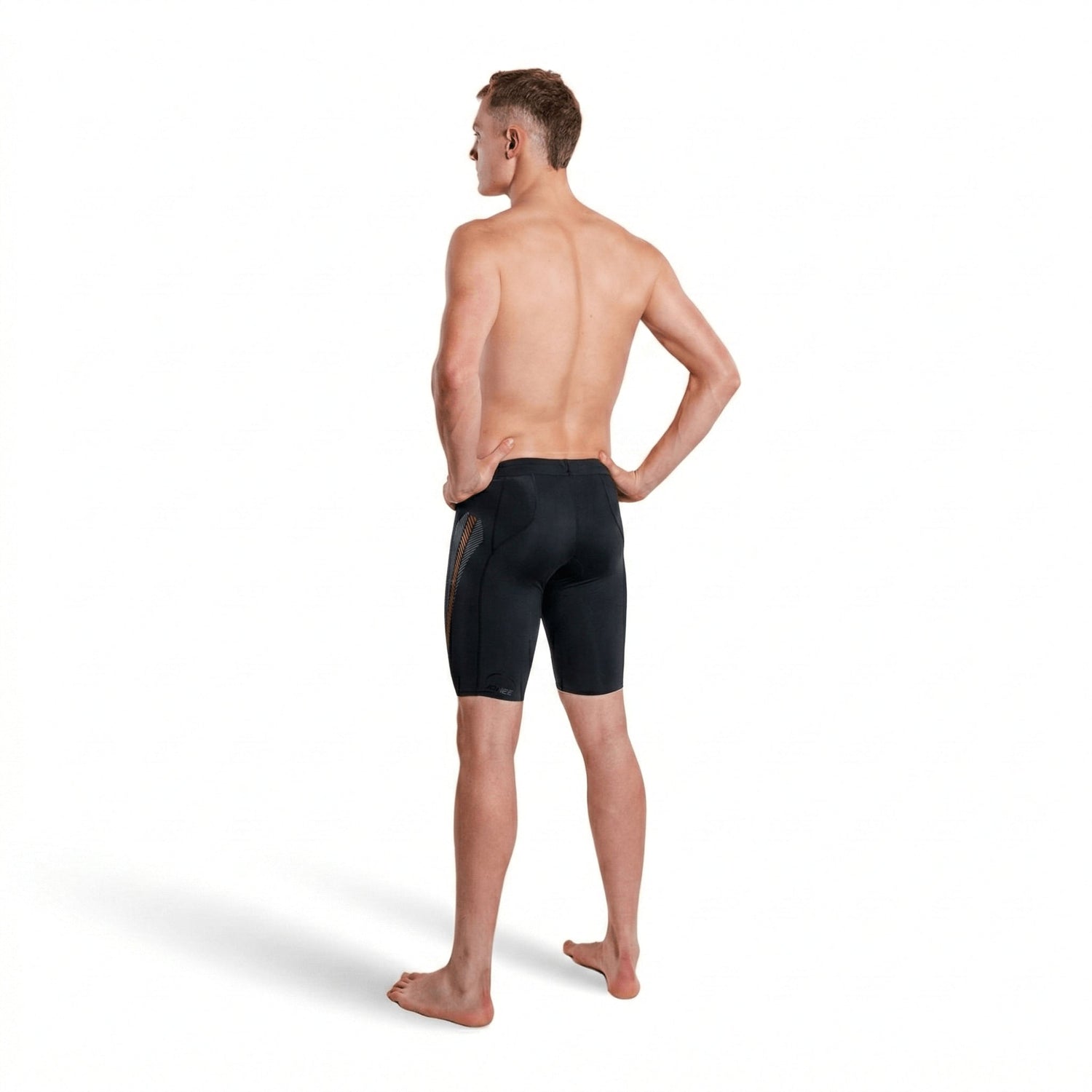 Back view of a shirtless man wearing black Buoyancy Shorts 5/3mm wetsuit shorts.