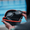 Open navy goggle case showing Zone3 swim goggles with water droplets on the lenses.